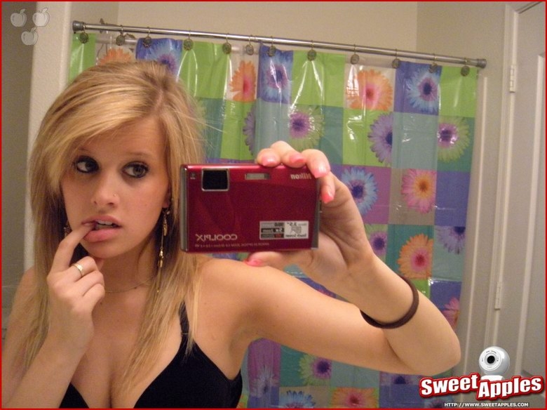 Alisa poses before a mirror