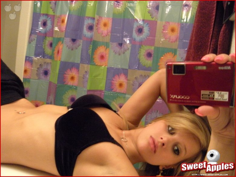 Alisa poses before a mirror