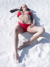 Suzie pulls down red bikini in sand