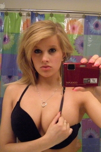 Alisa poses before a mirror